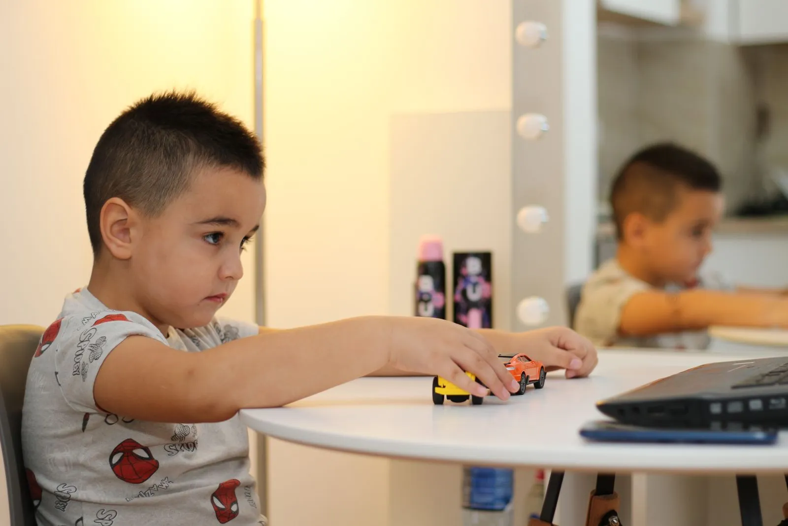 Illustrative photo of a child playing with toy cars at home
