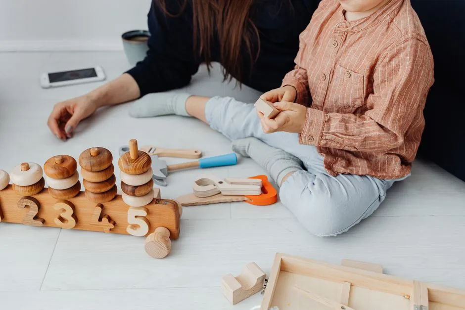 Illustrative photo of a parent playing with a child and wooden toys
